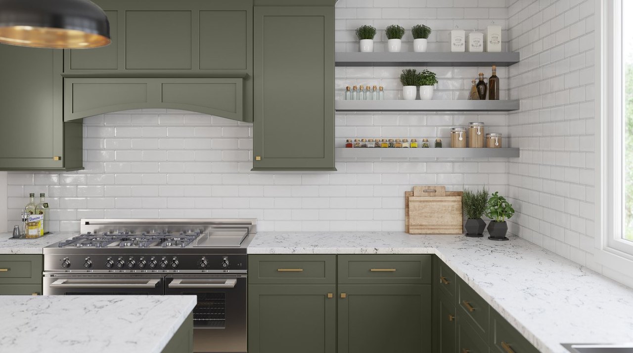 Fabuwood Galaxy forest green shaker kitchen with white subway tile and veined quartz countertops