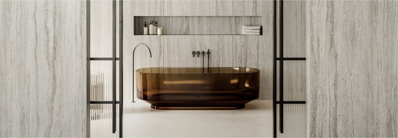 Dekton Trevi wet wall in a bathroom — full-height stone cladding with no grout lines (Cosentino application imagery)